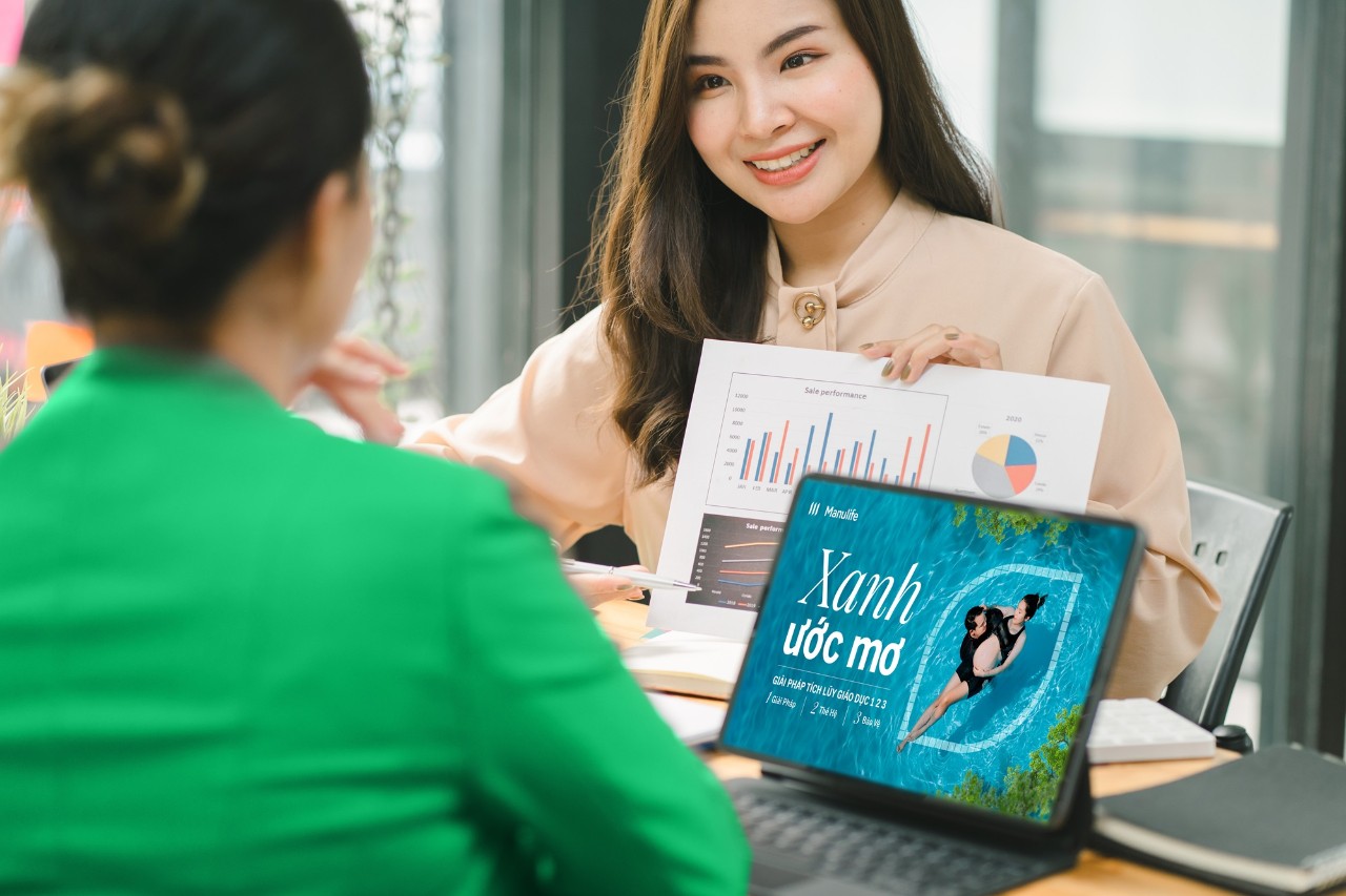 Two businesspeople or an accountant team are analyzing data charts, graphs, and a dashboard on a laptop screen in order to prepare a statistical report and discuss financial data in an office